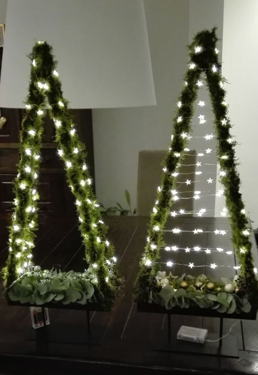 Wrap your tree shapes with faux greens and string lights for a unique look!