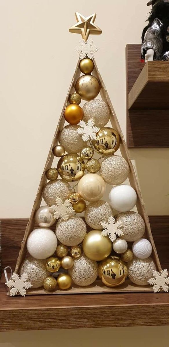 Here's a rustic triangle tree with a white and gold color scheme and some snowflake decorations.