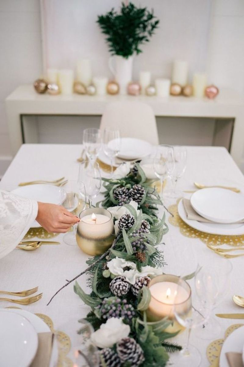 Decorate with a mix of pinecones, white candles and Christmas greens.