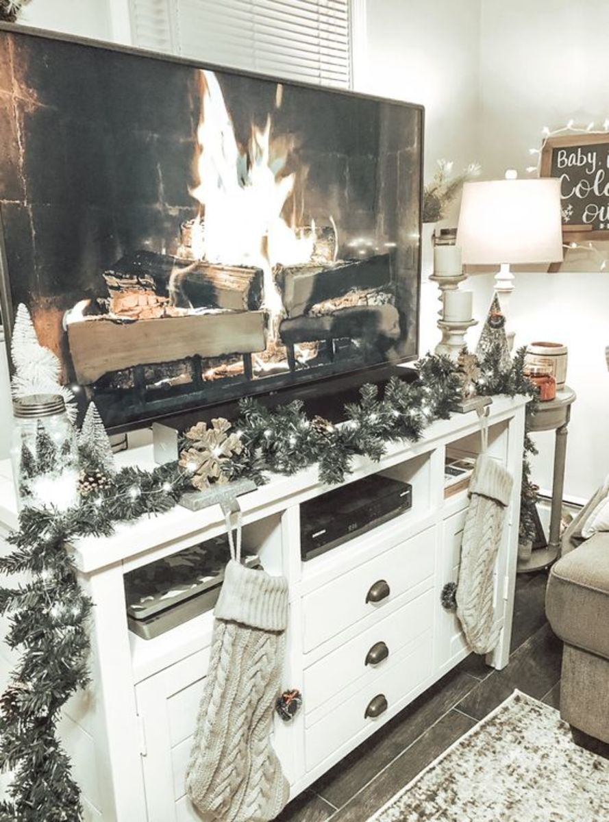 Hang stockings and string lights on your entertainment center. Don't forget to put a YouTube fireplace video on the TV!