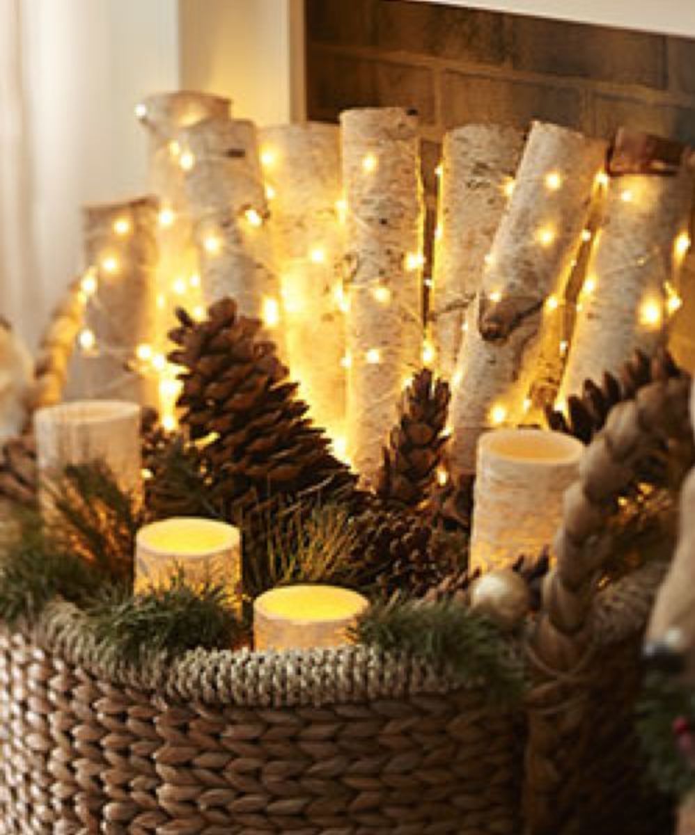 Place faux birch logs, pinecones and string lights in a basket.