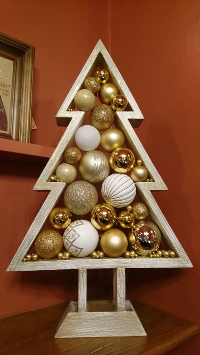 If you're filling the tree with gold baubles, why not also paint it gold!