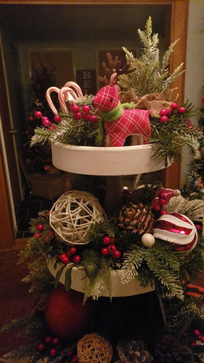This tray focuses on faux pinecones, berries and greenery, with a few ornaments and candy canes for accents.