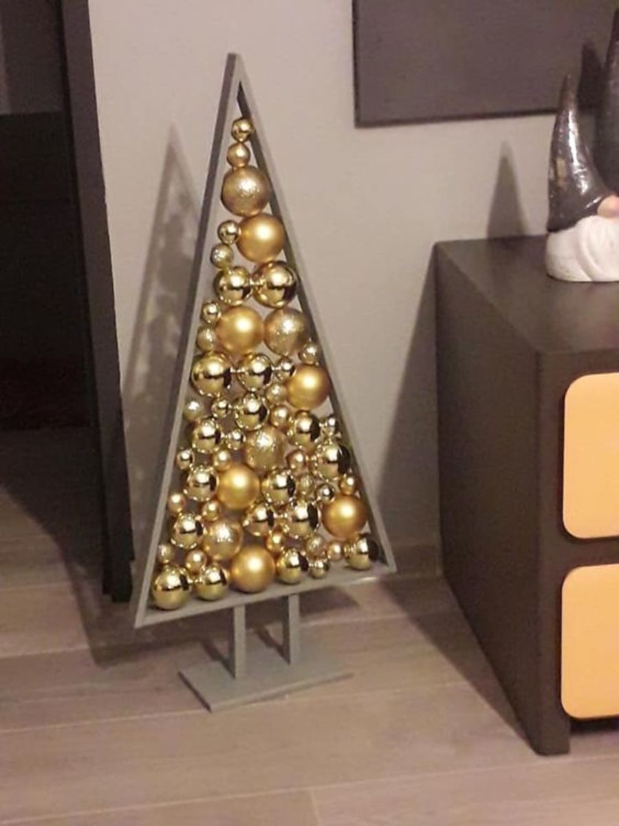 The grey paint on this tree is understated, and it sets off the bright gold baubles.