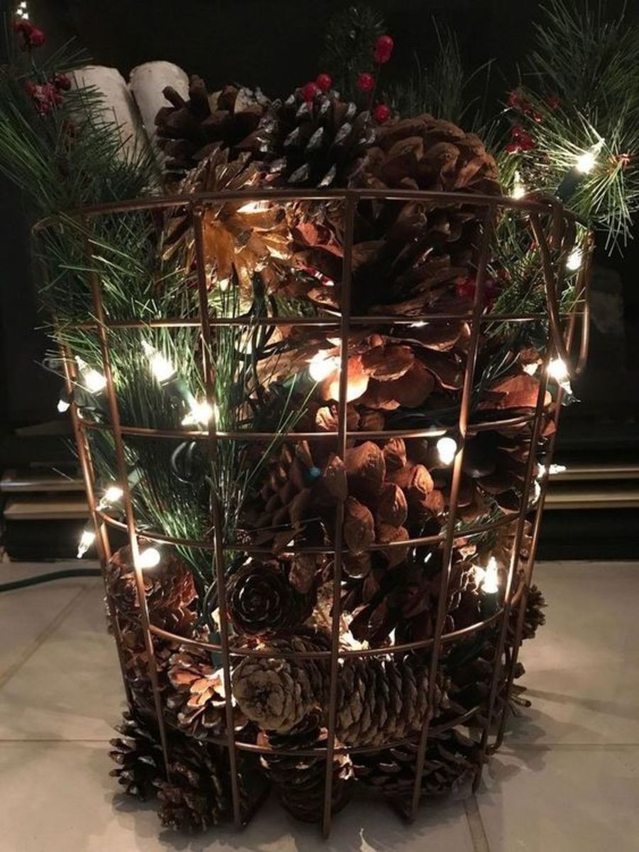 Fill a wire basket with pinecones, greens and string lights.