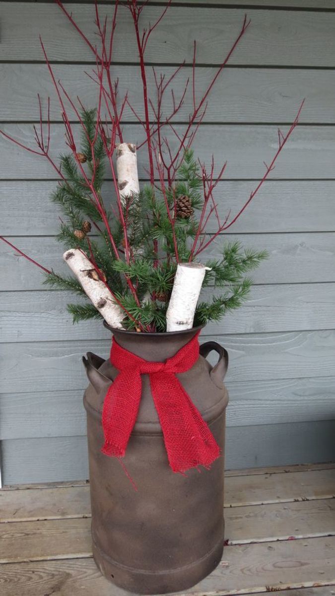 Fill an old milk crate with Christmas greens, then tie on a red burlap bow.