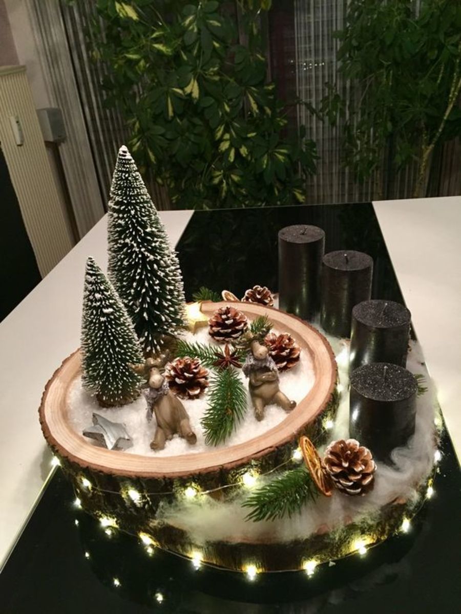 Make a table centerpiece out of wood slices displaying a miniature Christmas village.