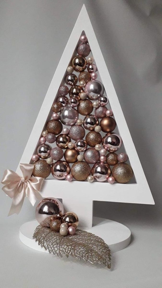 Painting the tree forms white is a popular idea! This one is filled with rose-gold baubles.
