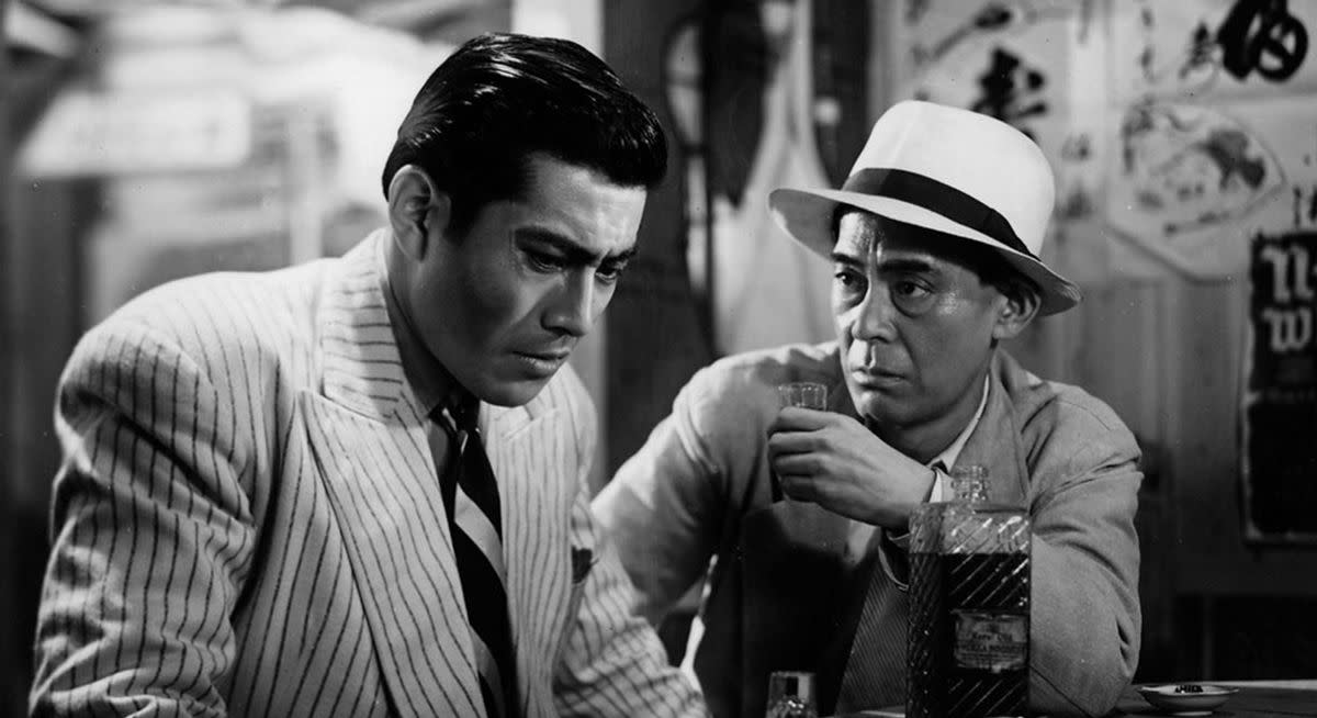 Mifune (left) shows a different side from his standard 'samurai' character, delivering a charismatic but unsettling performance as suave yakuza Matsunaga.