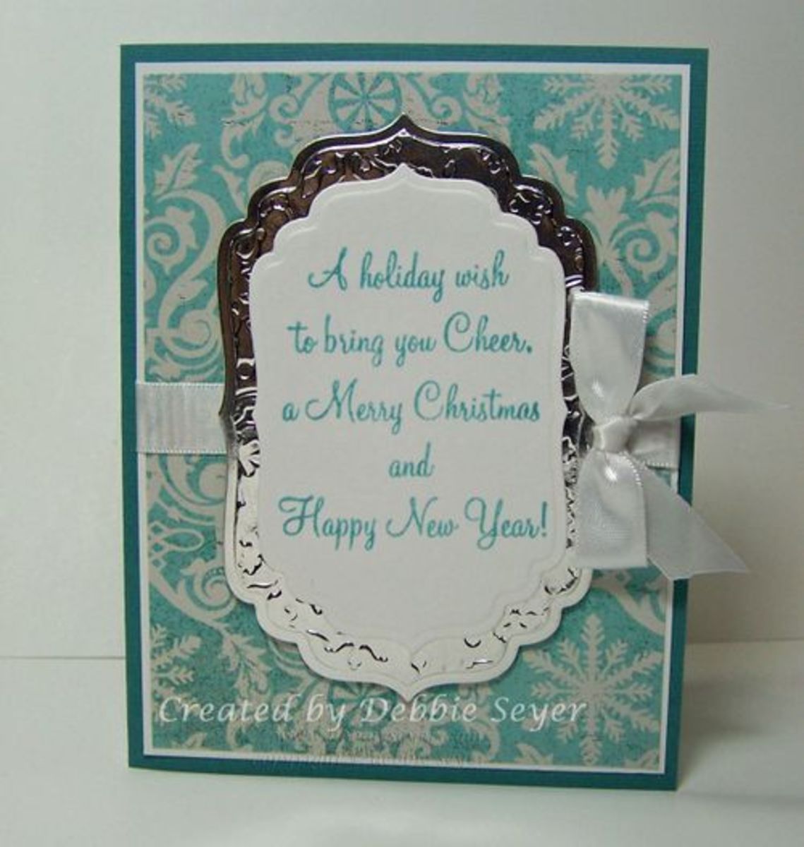 A foil embossed frame makes if lovely sentiment background in this card