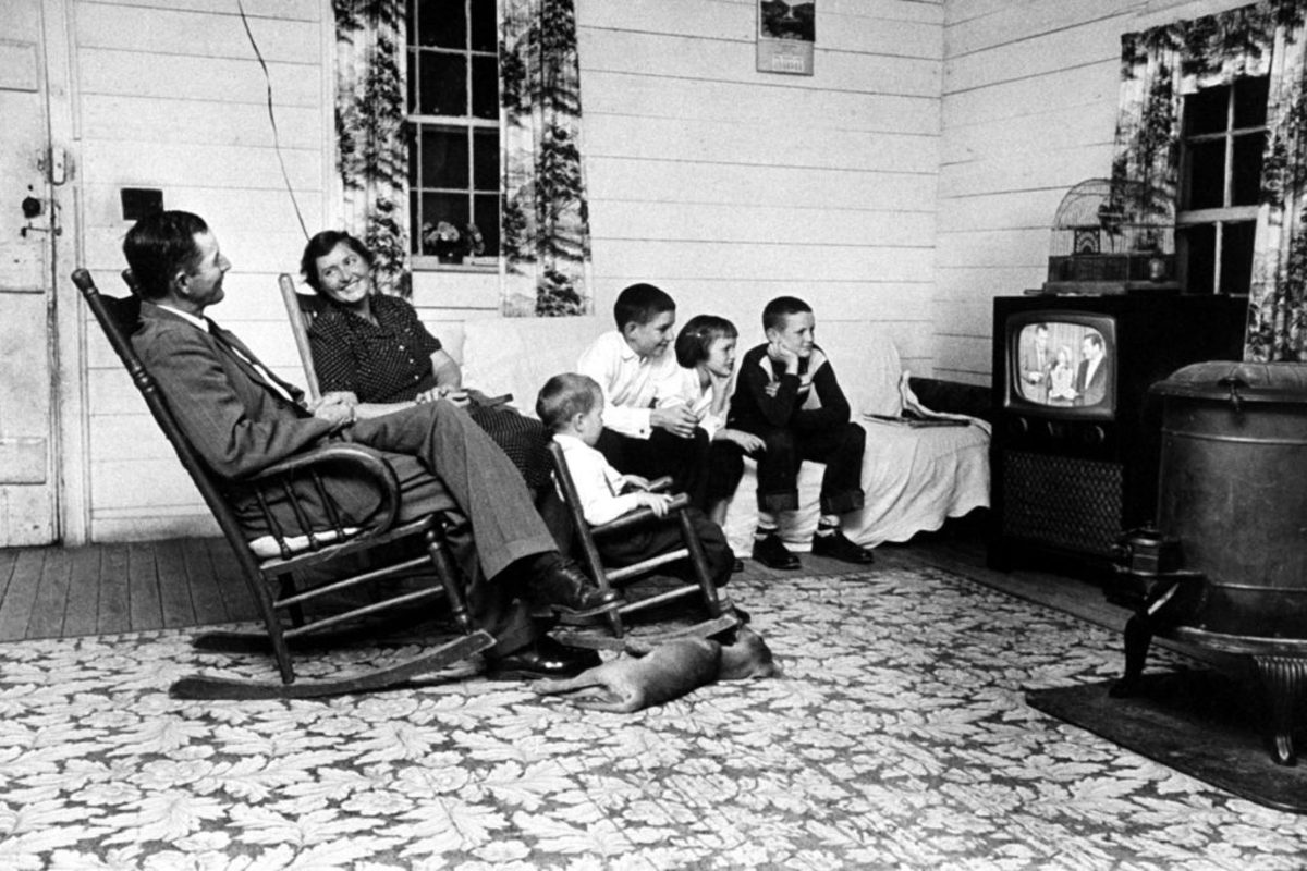 Mother, father, the kids and the dog, all watching television back in the late 1950s.