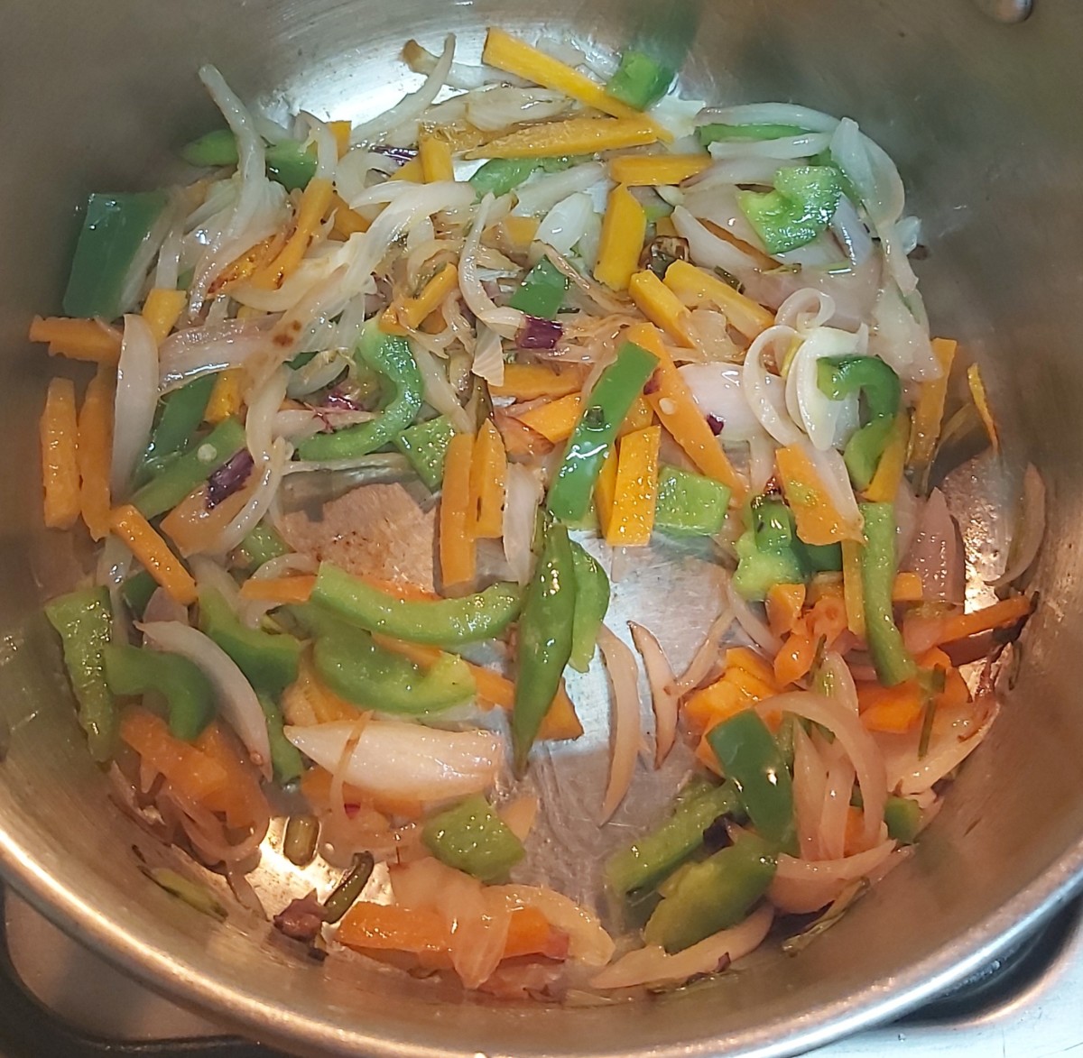 Add chopped carrot and capsicum. Fry for 1 minute over high flame. Do not overcook the vegetables. They should remain crunchy.