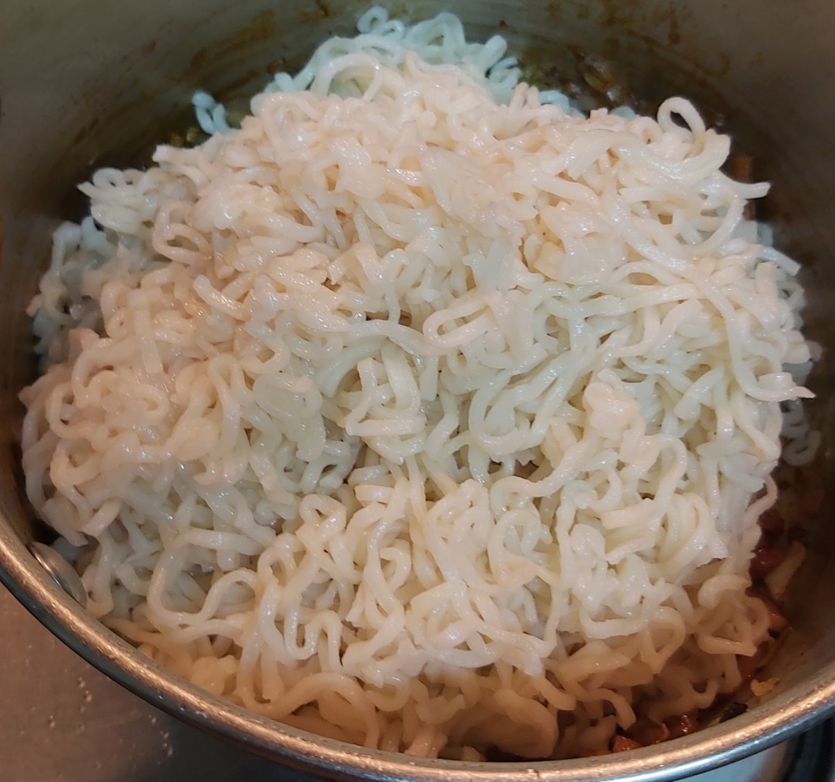 Add cooked noodles back into the pan.