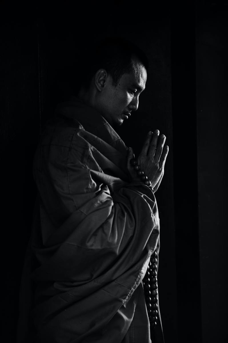 Silhouette of a man in prayer