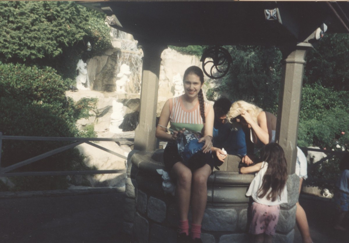 Picture of me sitting on top of Snow White's Wishing Well (1994).