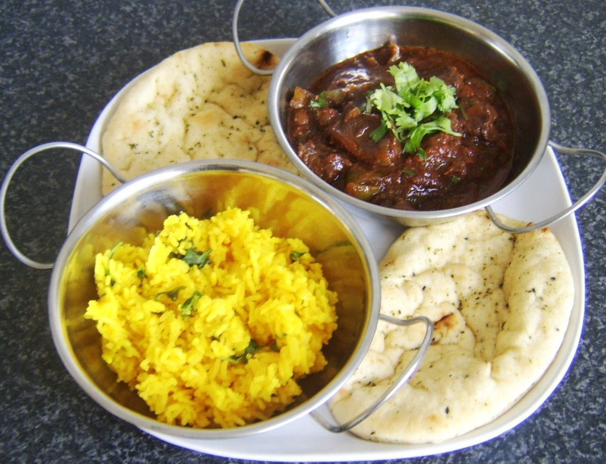 Mutton curry served with spicy rice and naan breads