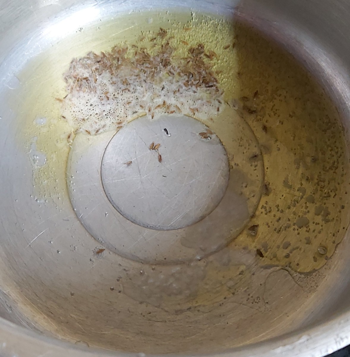 In a cooker take 2 spoons of ghee. Once ghee is hot add 1 teaspoon of cumin seeds. let it splutter.