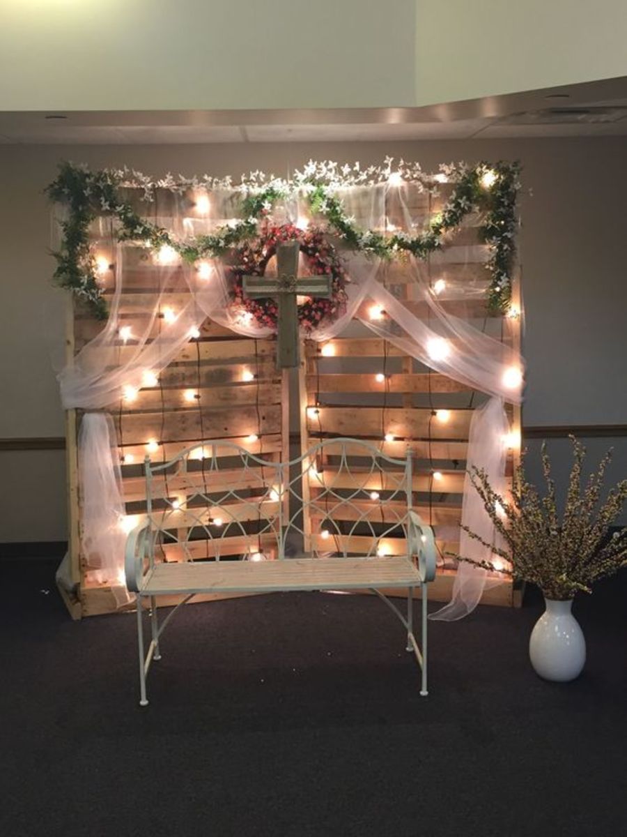 Rustic pallet backdrop with chiffon, faux flowers, and fairy lights