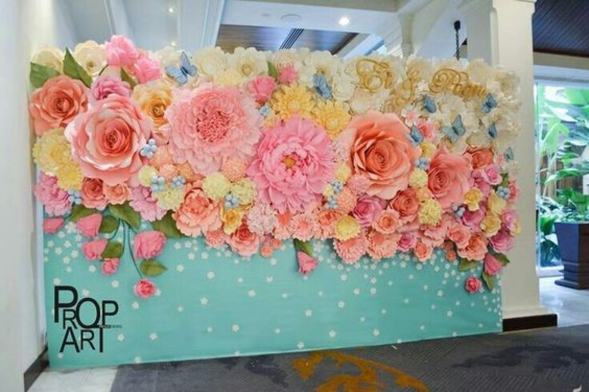 Gorgeous mix of pink and yellow flowers on a light blue backdrop
