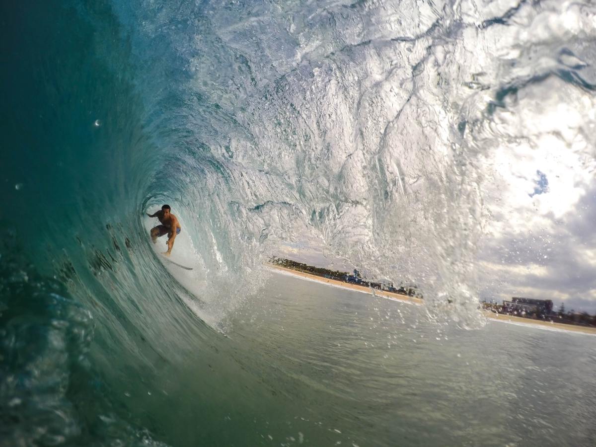 When the wave curls over to form a tube, they call that the barrel. If you get barrelled, you get enclosed by a wave.