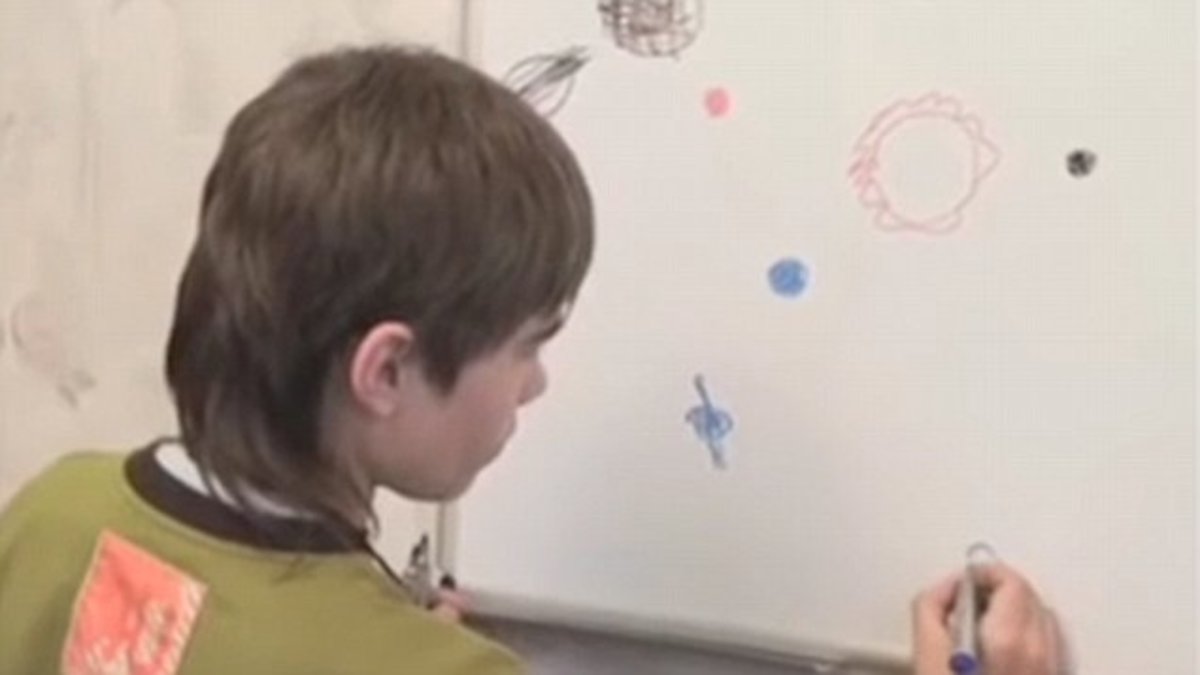 Young Boriska Kirpriyanovich explaining planets