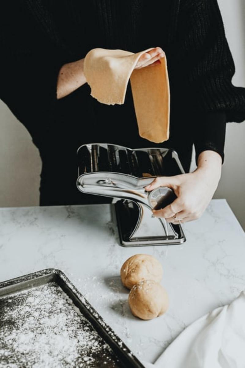 Use a pasta machine to flatten the dough. 