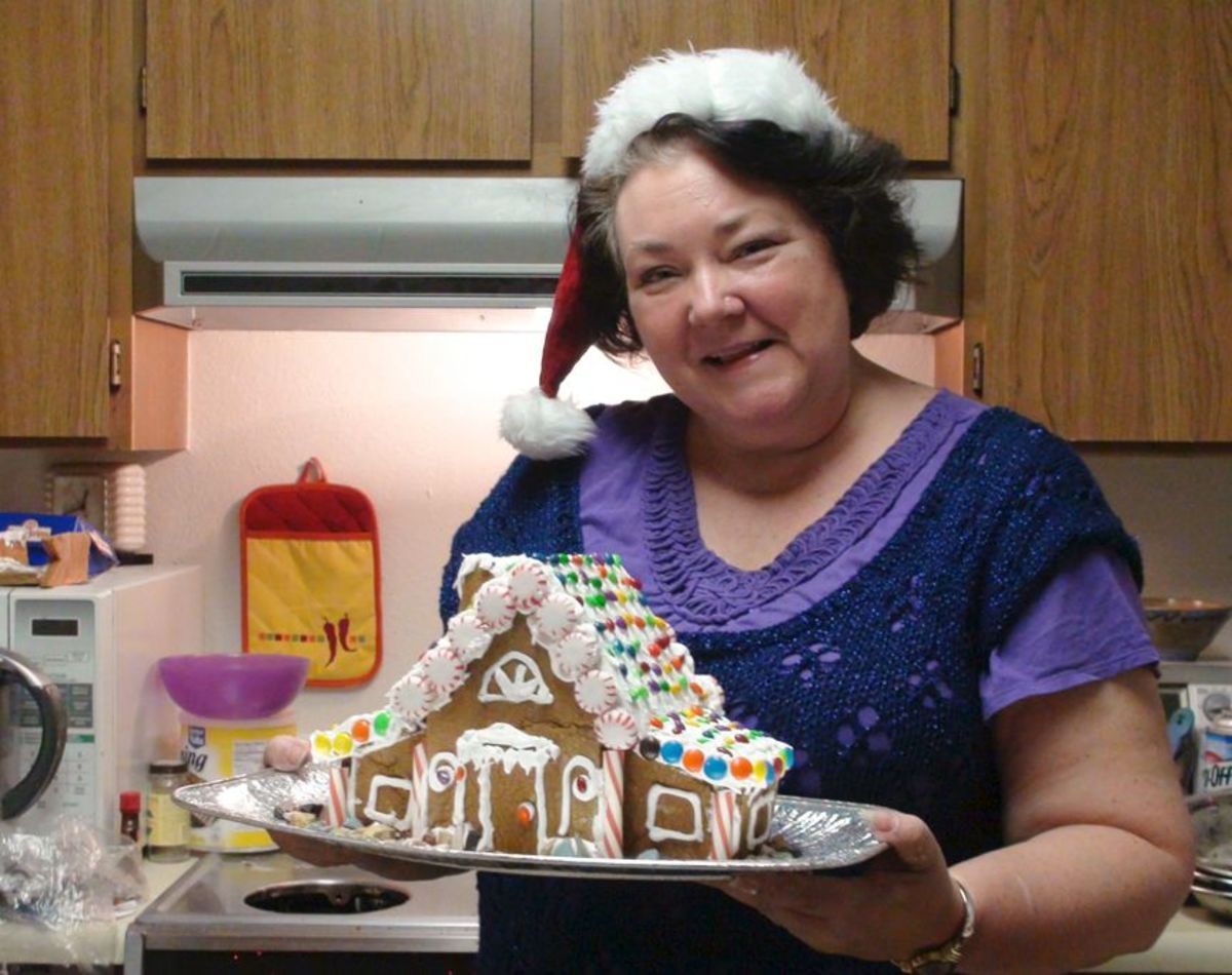 My husband took the photo of me and one of my Gingerbread House creations.
