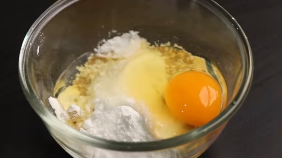 In a bowl, combine all-purpose flour, corn flour, baking powder, salt, pepper, and one egg. Mix well.