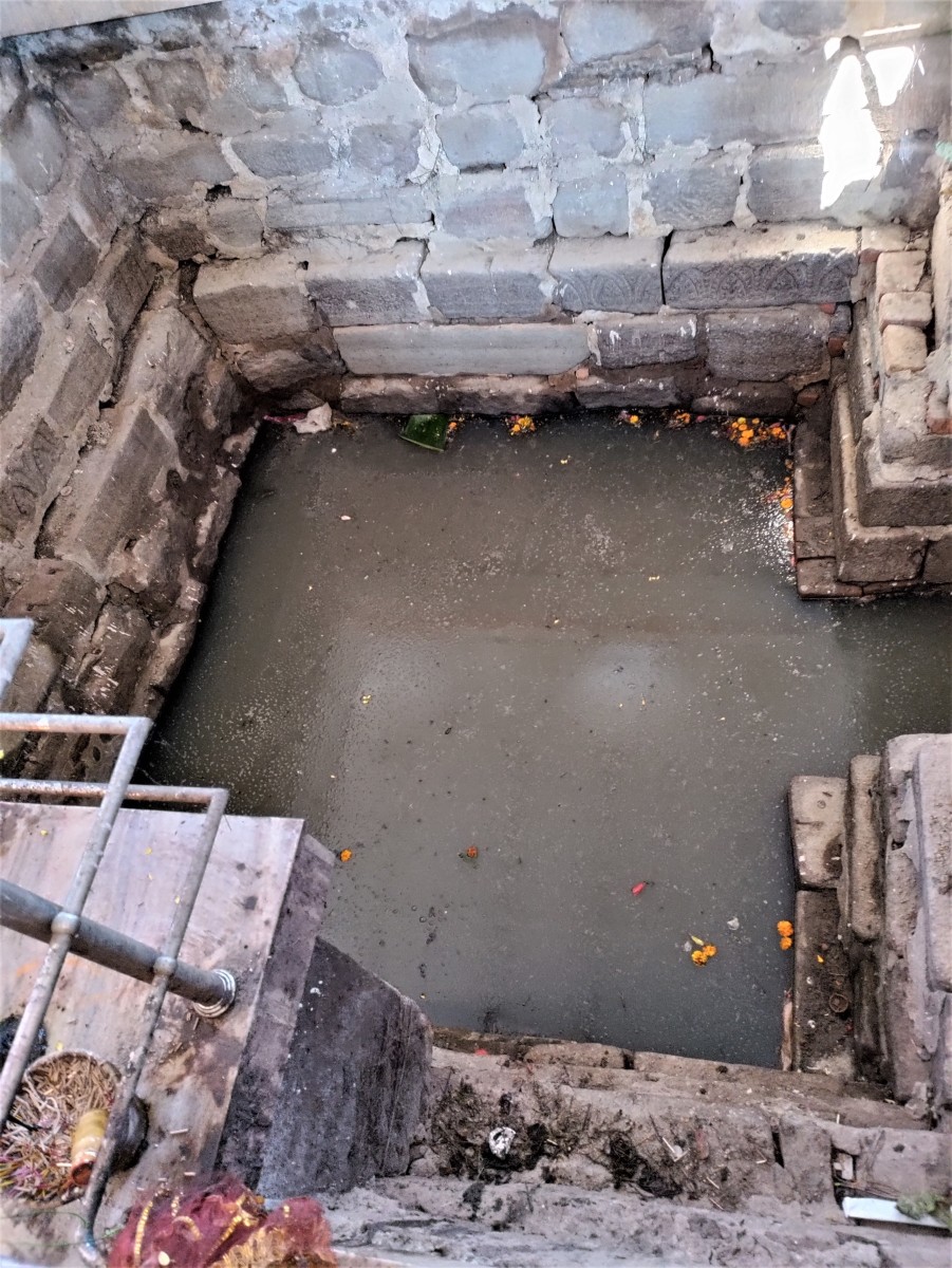 The small tank or "Kund" filled with water in the sanctum of Naga Shankar temple