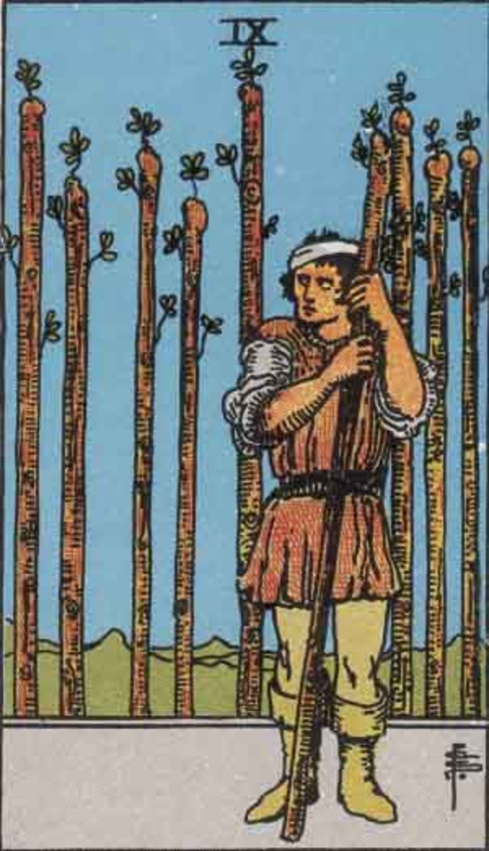 The Nine of Wands shows a distressed man. He is wounded. There are bandages on his head. He stands among eight tall sticks. He holds a stick close to him, like a crutch.