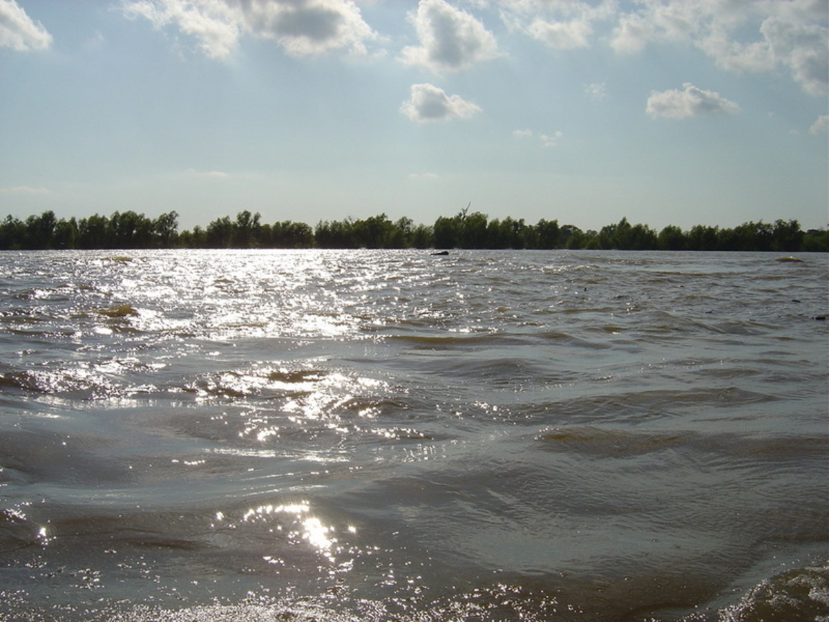 The beautiful waves of the lower Mississippi River, highlighted by the sunlight and clouds overhead.