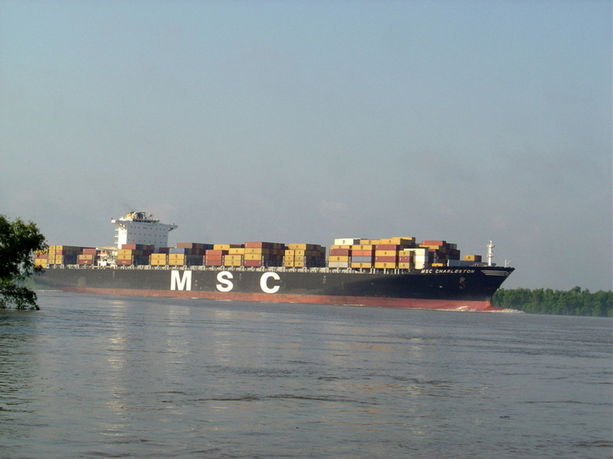 The crew of a large container ship has access to the mouth of the Mississippi. as it carries truck-sized containers, plying the river.