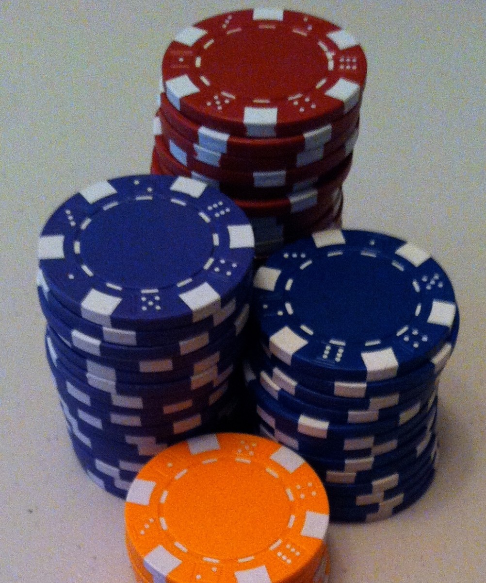 Various colored chips that could be used in a game of roulette.