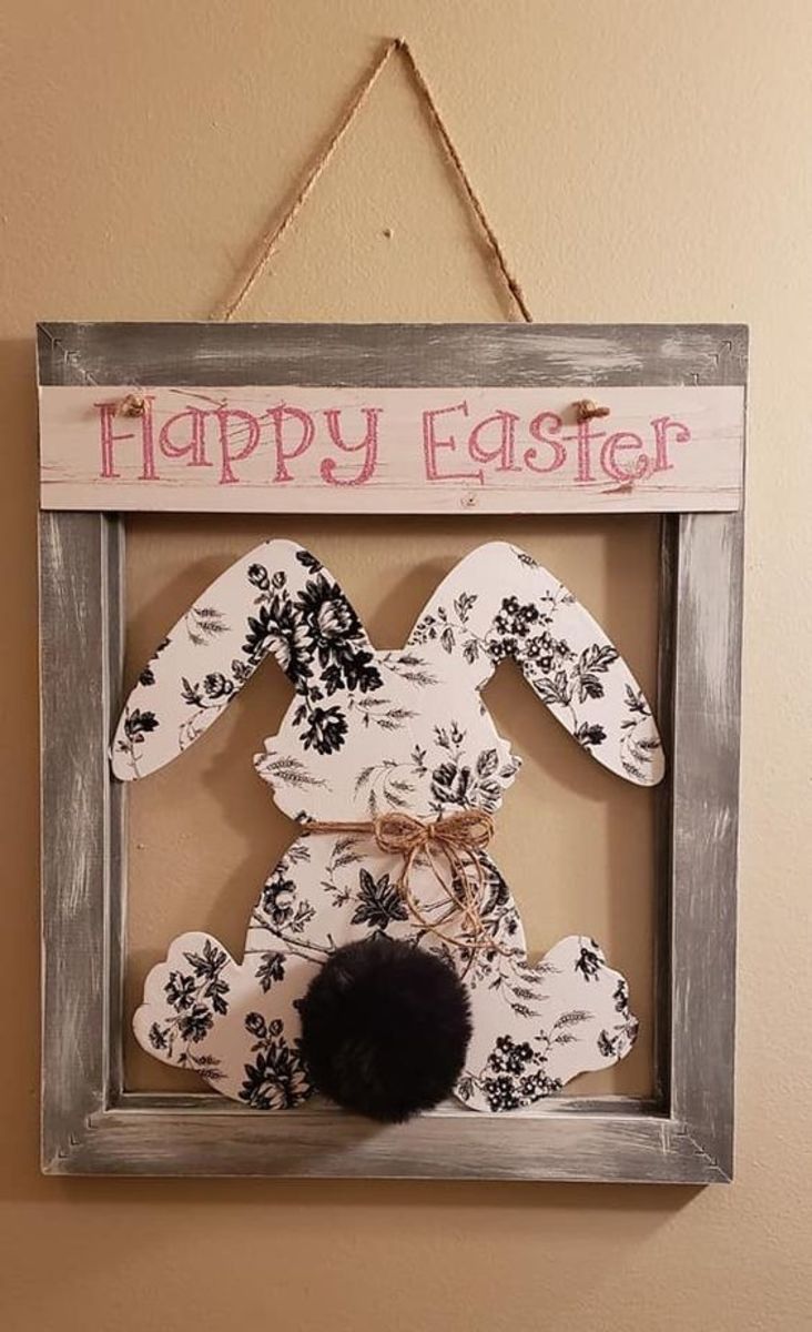 Combine a frame with a decoupaged wooden bunny and a pompom, and you have this cute wall hanging.