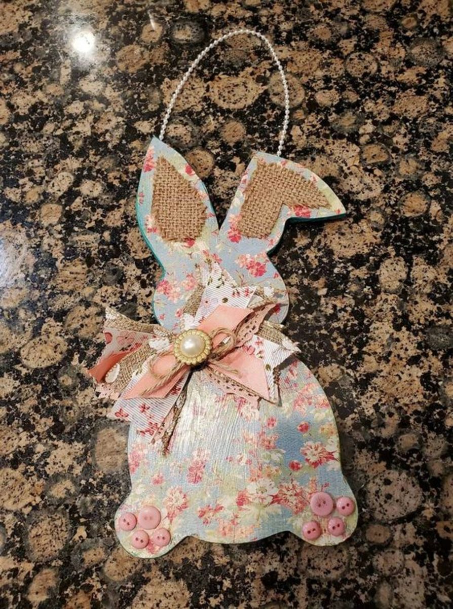 You can also decoupage the wooden bunnies to decorate them. I love the pink buttons for the toes!