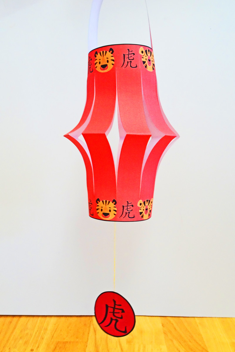 Here is another version of the cut paper lantern, which chas the Chinese character for tiger and small tiger faces around the top and bottom border of the lantern.