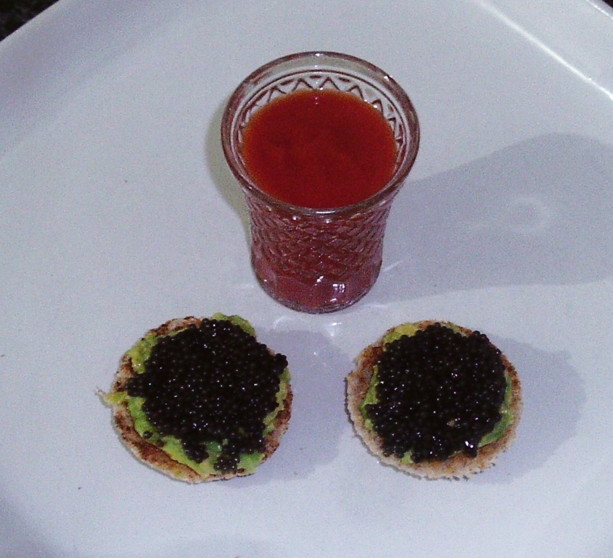 Caviar and spiced avocado on toast is served with a Bloody Mary shot
