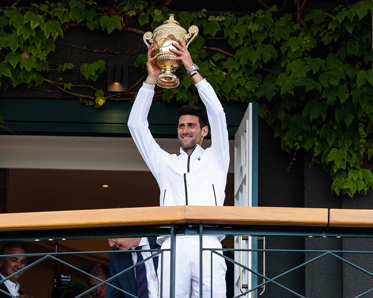 Novak Djokovic holds aloft his Wimbledon Men's Singles Trophy in 2019.