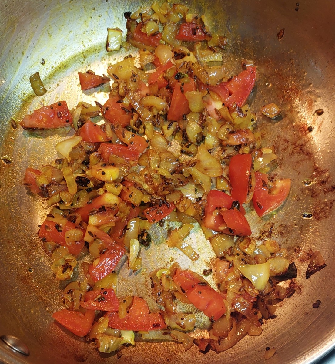 Add chopped tomato and fry for 1 minute or till tomatoes turn mushy.