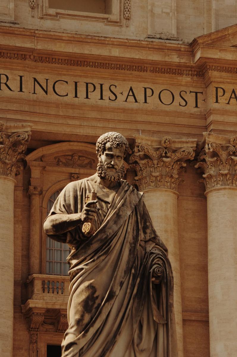 Monumental statue of St. Peter the Apostle holding a key, in front of St. Peter’s Basilica, Vatican City.