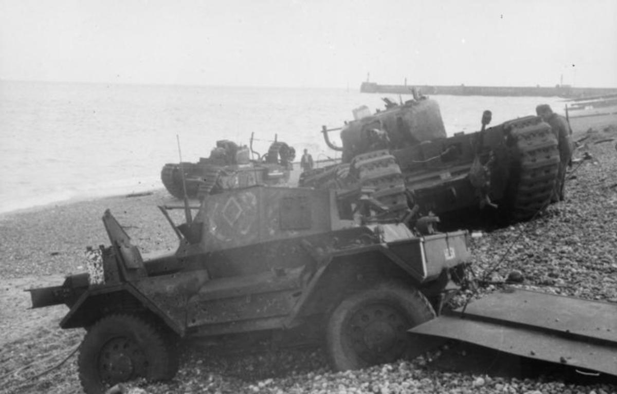 Daimler Dingo armoured car in the foreground on the shingle beach with a pair of Churchill tanks behind