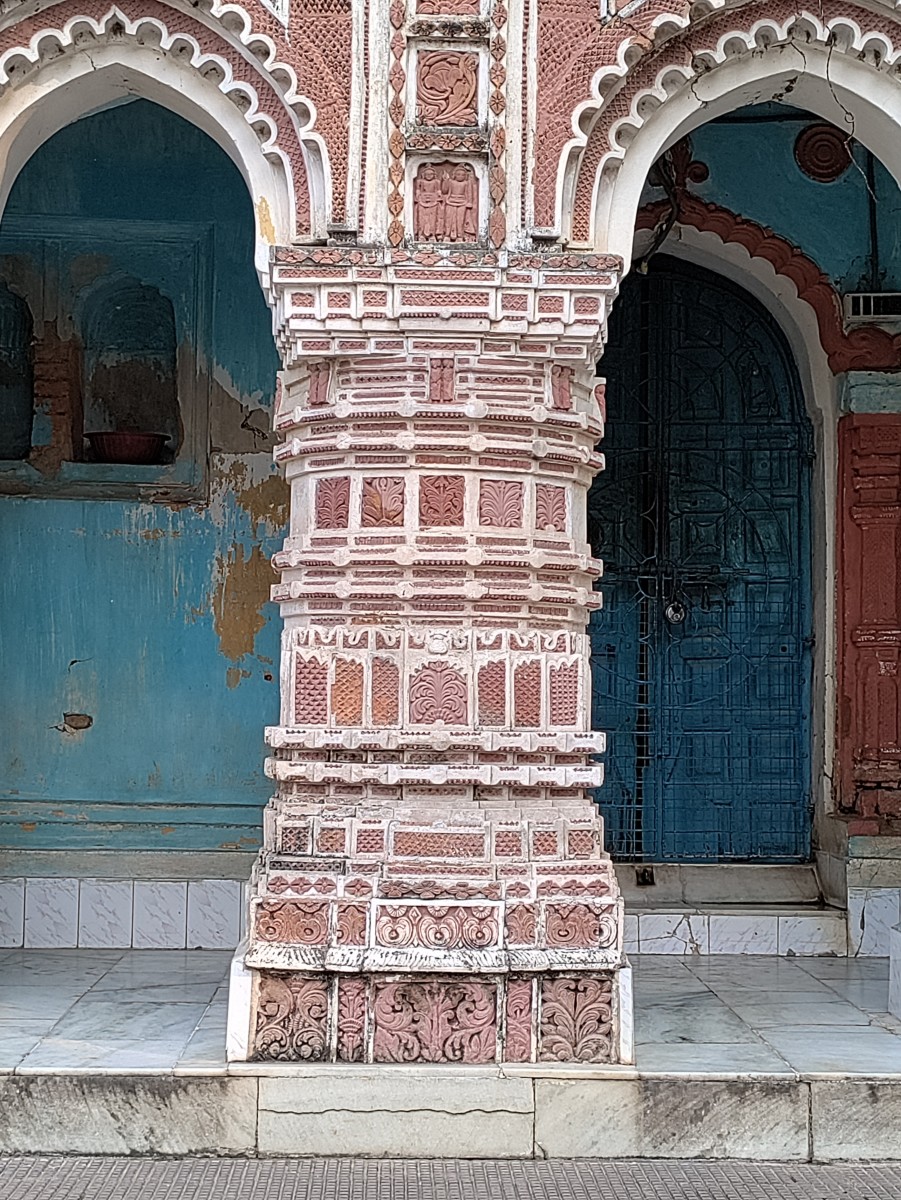 A pillar on the front of the temple with rich terracotta decorations