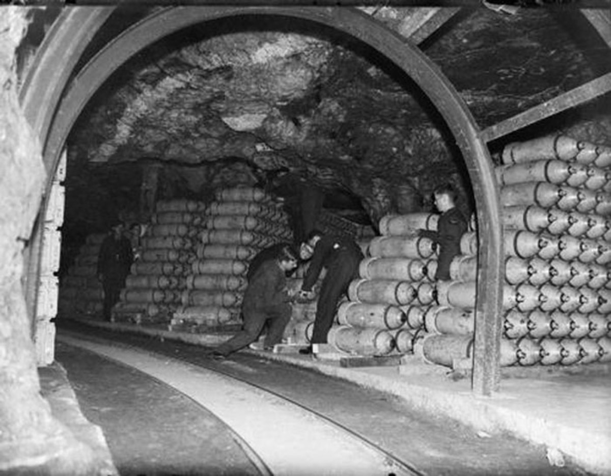 Storemen stack 250-lb MC bombs in one of the tunnels at No. 21 Maintenance Unit at Fauld, near Hanbury, Staffordshire. RAF Fauld, situated in a former gypsum mine, was the main repository of high explosive ordnance in the country.