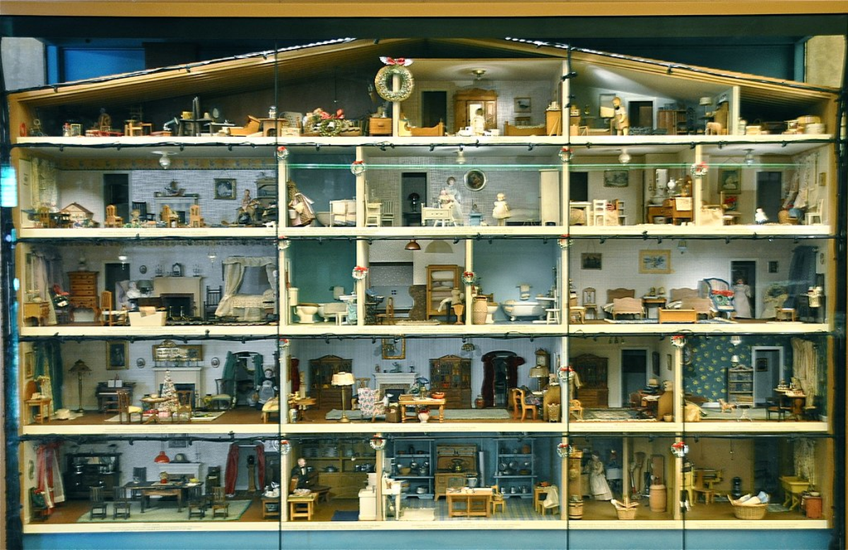 American - Vintage miniature dollhouse showing numerous internal rooms.