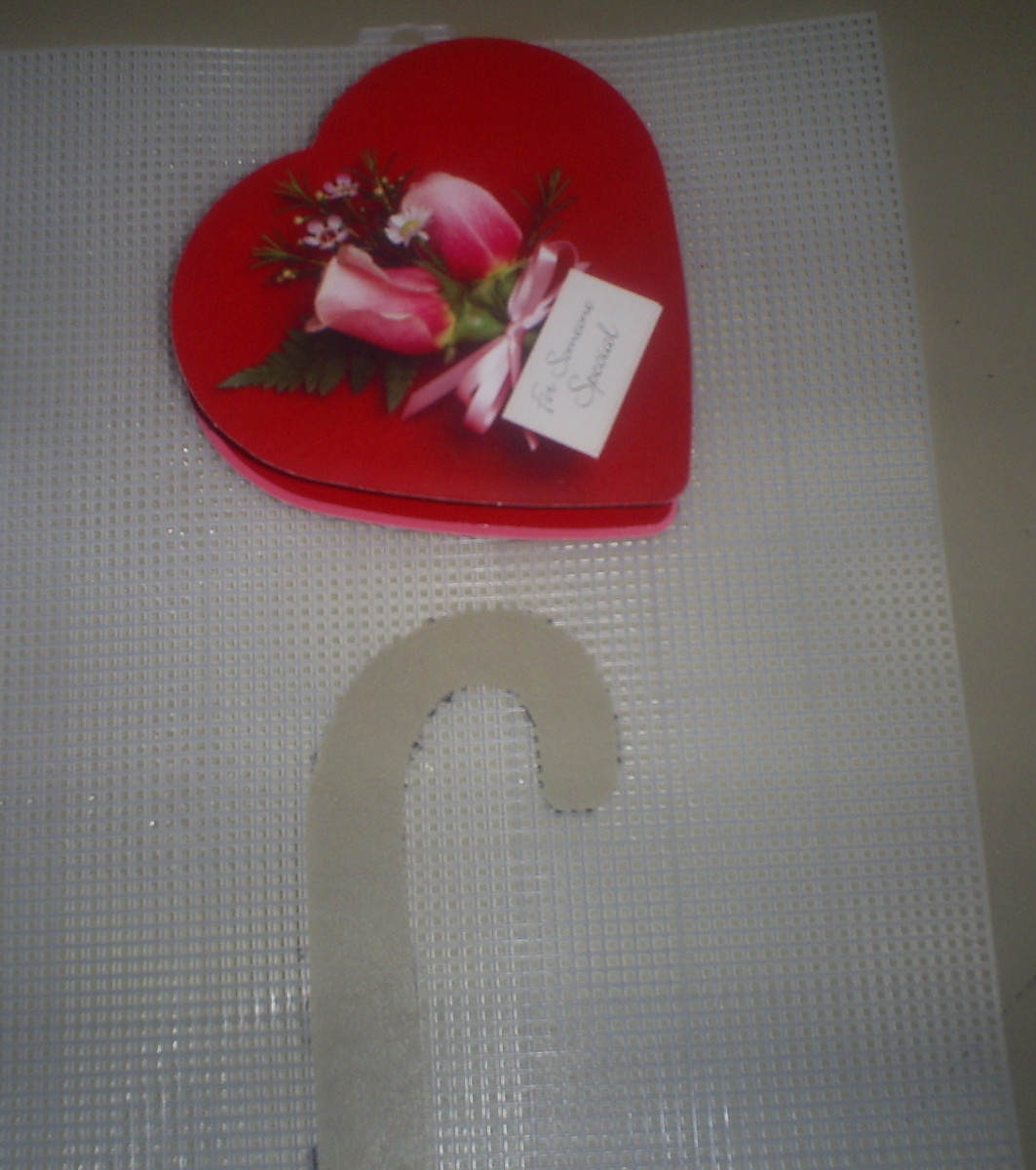 Find a plastic canvas mesh and heart shaped candy box as the template for this project.