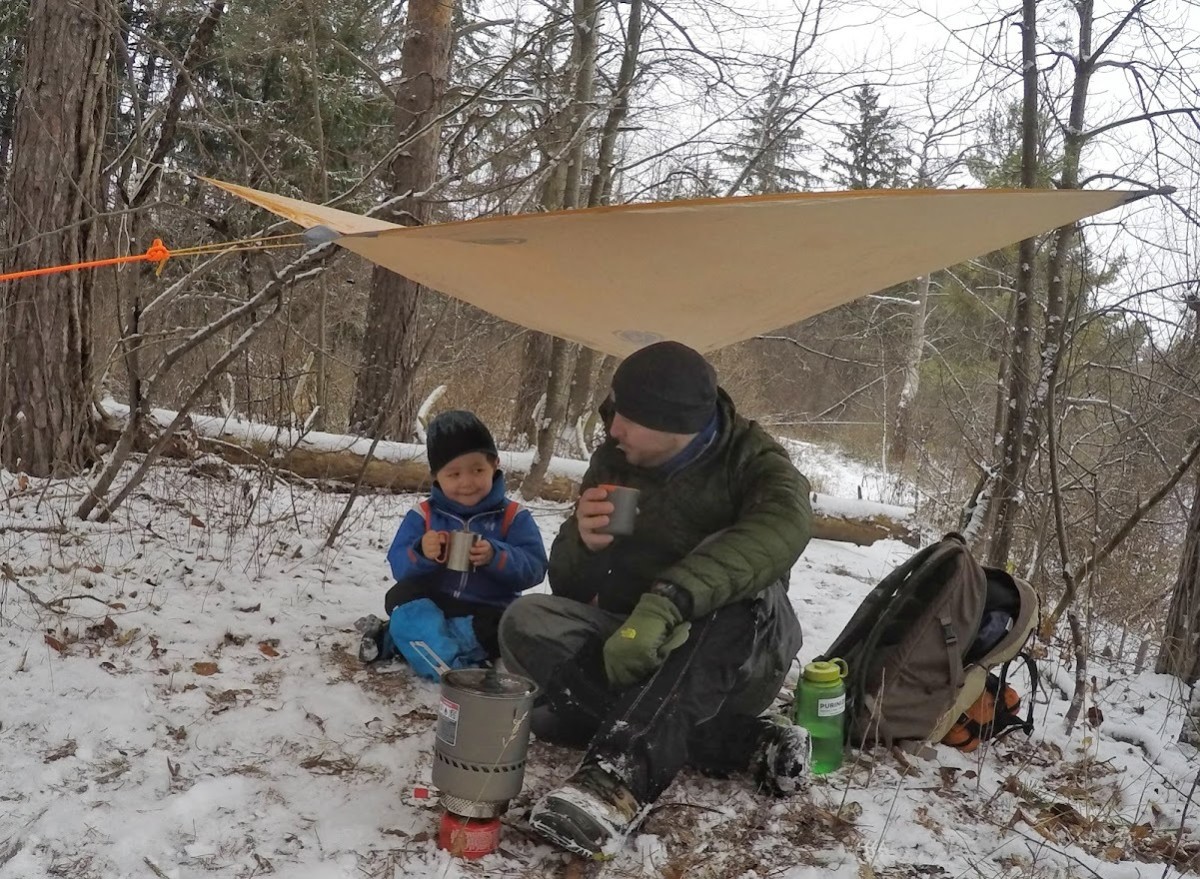 Enjoying cocoa on a break while winter hiking with my son. 