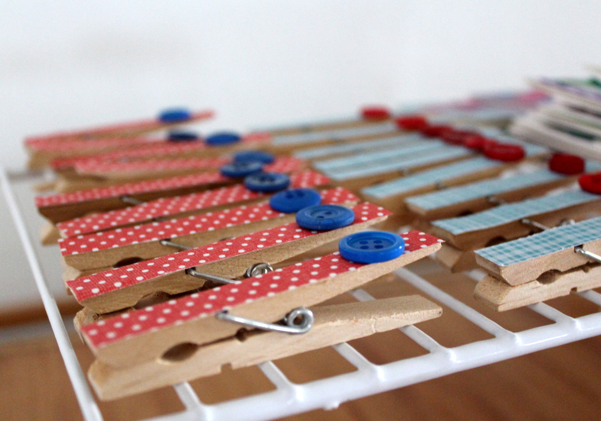 I covered my first set of clothespins in scrapbook paper, but you can easily modify this concept with washi tape.