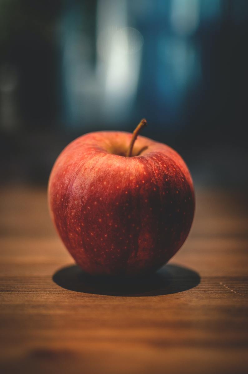 The apple is often understood as a metaphor for the forbidden fruit of the tree of knowledge.