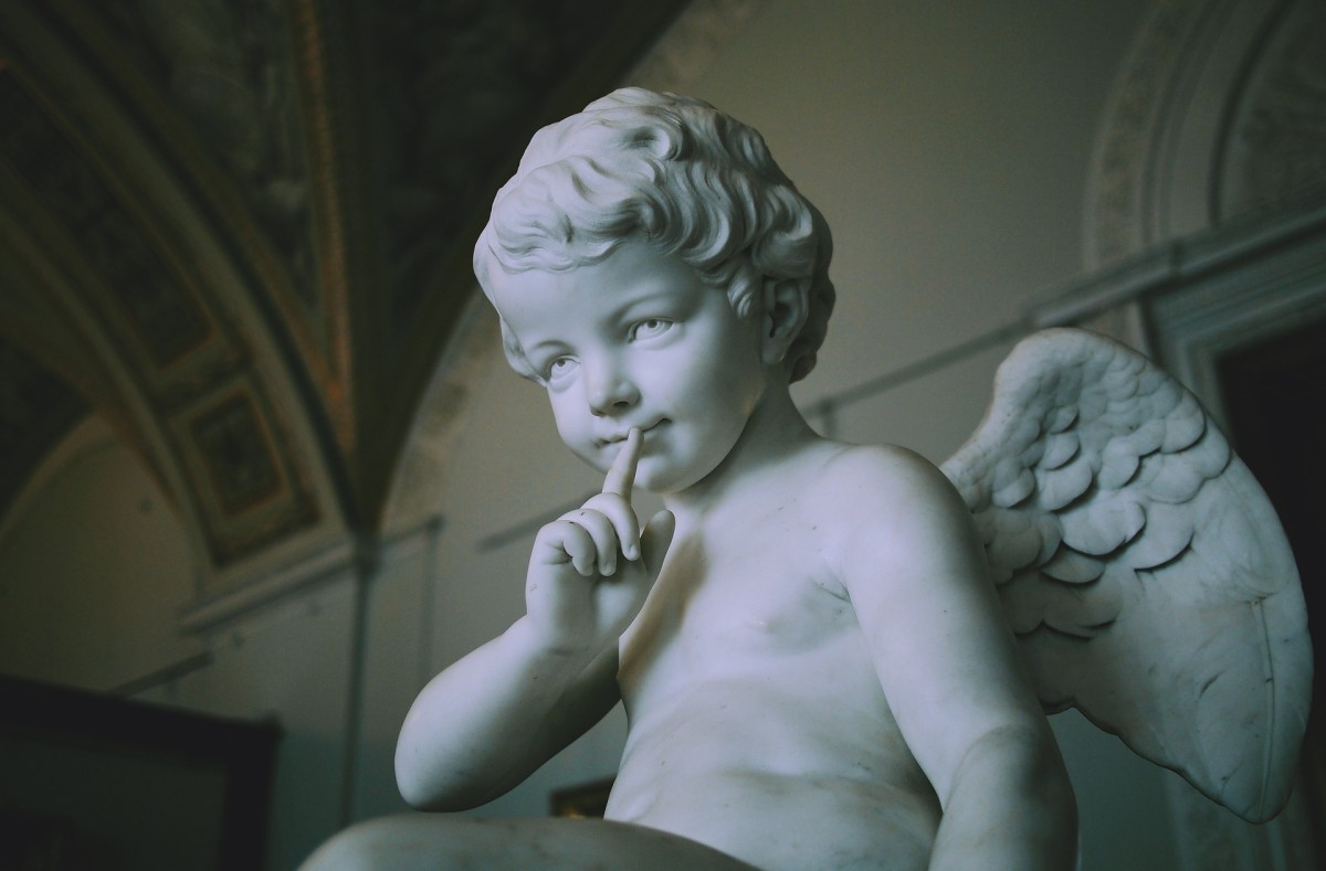 A boy angel sculped from marble. 