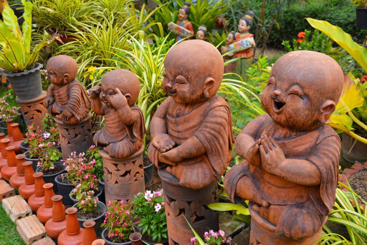 A short lineup of garden gnomes molded from clay. 